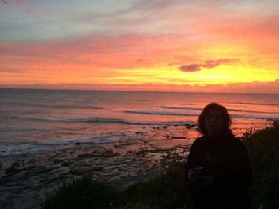 Terese contemplating emotional healing in the sunset